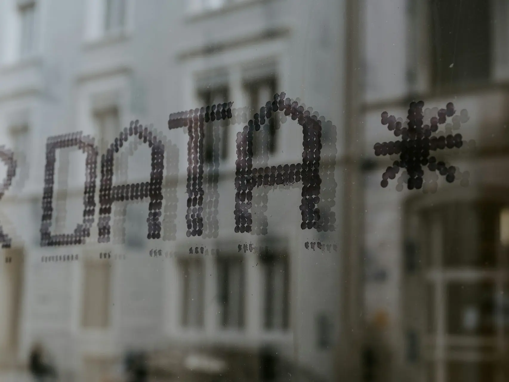 a close up of a window with a building in the background