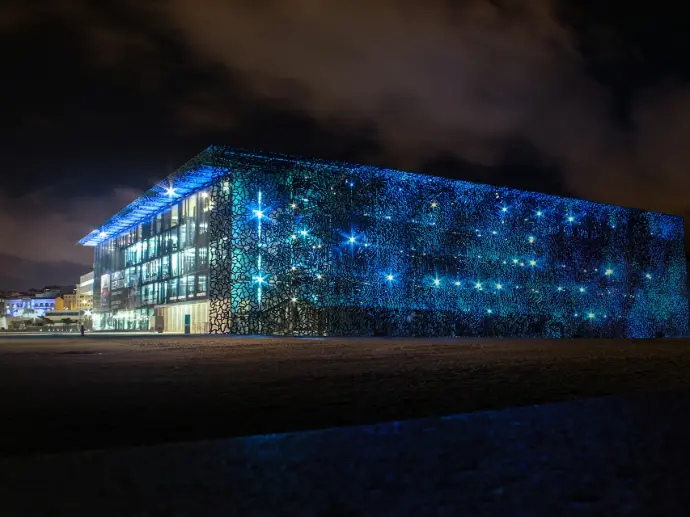brown concrete building under white clouds during daytime